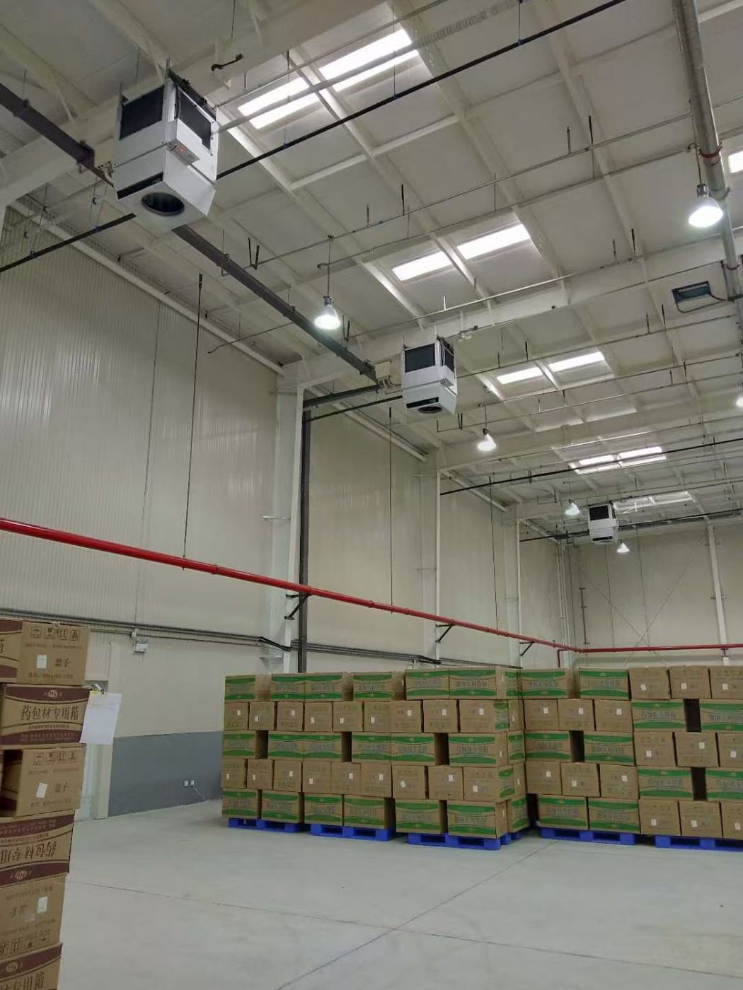 An installed OXA ceiling unit in a completed warehouse — ductless installation