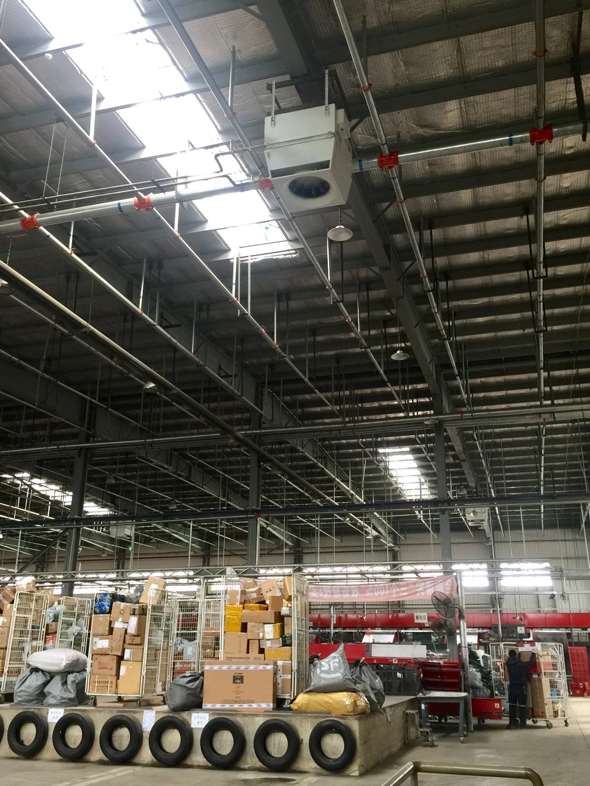 warehouse heating — Mycond OXA units above the racking in a logistics centre
